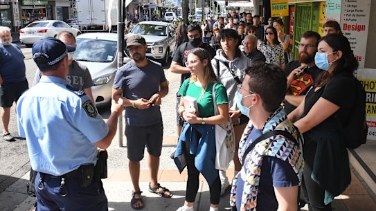 Police explain to hundreds lining up outside a Centrelink office in Sydney that they will have a long wait.