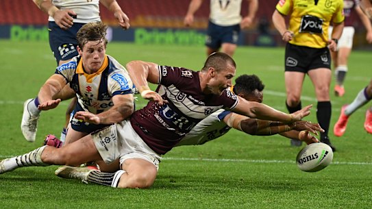 Kieran Foran battles to get to the ball first.