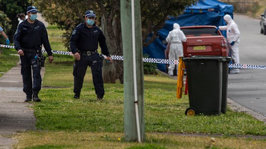 Police investigators at work in William Street, Blacktown, on Thursday morning after an 18-year-old man was fatally stabbed during a brawl.