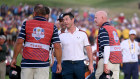 Rory McIlroy makes a point to a Team USA caddie on the 18th green during the 2023 Ryder Cup in Rome.