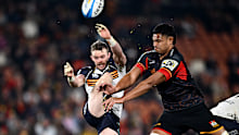 Ryan Lonergan of the Brumbies' kick is charged down by Tupou Vaa'i of the Chiefs.