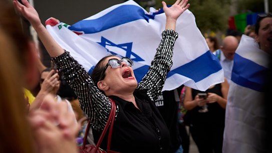 People in Tel Aviv celebrate after waking to the news that Israel and Hamas had agreed to the first phase of a peace plan.