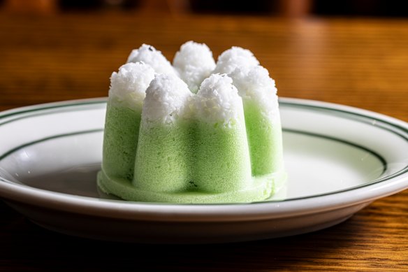 Putu ayu, pandan sponge topped with grated coconut.