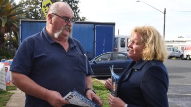 Liberal candidate Julia Ham hands out how to vote cards on Thursday