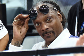 Snoop Dogg watches the gymnastics.