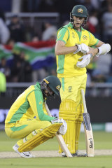 Australia's Nathan Lyon, left, and teammate Jason Behrendorff react after losing to South Africa.