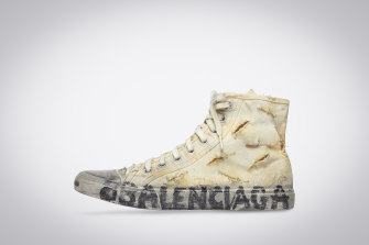 Fashionable sneakers, such as this Balenciaga deliberately distressed one, make an outsized contribution to climate change, even before they end up in massive dumpsites.