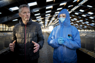 Mink breeder Peter Hindbo, left, and Danish Prime Minister Mette Frederiksen, right, during a visit to a closed mink farm near Kolding in November 2020.
