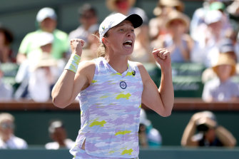 Iga Swiatek celebrates match point. 