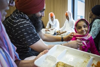 The Kaur family enjoys lunch at the Sikh Volunteers Australia appreciation awards.