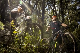  Joel Warham (r) owner of the Cog Bike Shop in Warburton and Andrew Howieson, President of the Yarra Ranges Mountain Bike Club, ride the ‘Hey Hey My My’ trail in the Yarra State Forest. 