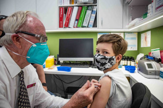 Thomas Hyslop, 10, gets his first COVID-19 vaccine dose.