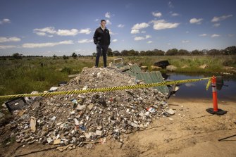 Hume mayor Joseph Haweil at a mound of illegally dumped waste in Craigieburn, in Melbourne’s north, on Tuesday.