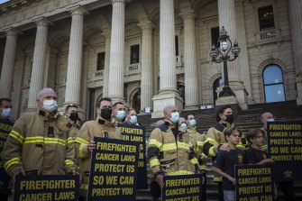 Firefighters on the steps of the state parliament last month, urging the government not to expand the compensation scheme. 