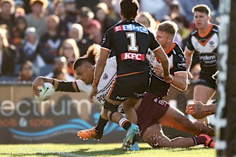 Haumole Olakau’atu crashes over for Manly against the Tigers.