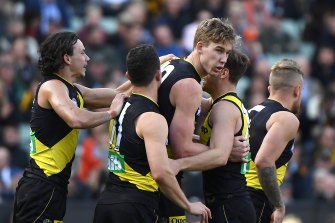 Tom Lynch is congratulated after kicking a goal in Richmond's grand final win. 