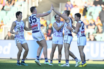 Fremantle celebrate a goal to Nat Fyfe in his 200th game.