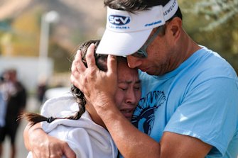 Ella Cabigting is embraced by her father Emerson as they reunite after the shooting at Saugus High School.