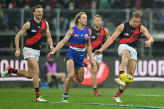 Darcy Parish gets a kick away for the Bombers.