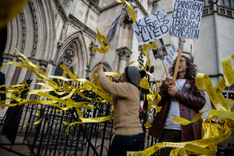 Protesters outside the Royal Courts of Justice in London demand that Julian Assange be freed.