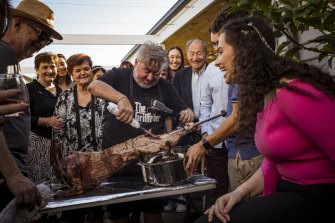 Jorge Menidis carves the spit-roasted spring lamb that he and his extended family enjoyed on Orthodox Easter Sunday.