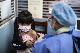 A child receives a vaccine against COVID-19 at a vaccination site on November 18, 2021 in Wuhan, China.