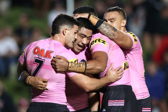 Moses Leota of the Panthers celebrates with teammates after scoring a try against Manly.