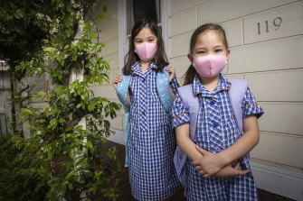 Grace and Sarah wear masks to school in 2021.