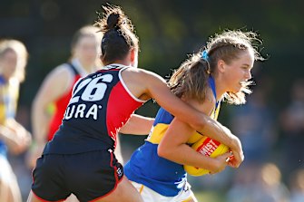 Charlotte Thomas of the Eagles is tackled by St Kilda’s Leah Cutting.