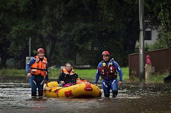 SES teams rescue Simone Baluch, her dog and a litter of kittens from a property in Chipping Norton on Thursday.