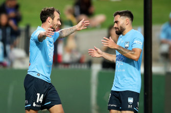 Adam Le Fondre and Anthony Caceres celebrate a Sydney FC goal.