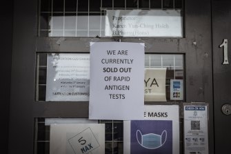 A sign posted to the door of a pharmacy on Nicholson Street in Carlton informs customers it has sold out of rapid antigen tests.