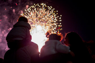 A family takes in the New Year’s Eve fireworks in Melbourne.