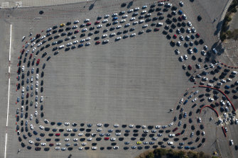 Motorists line up to take a coronavirus test in a parking lot in Los Angeles this week.