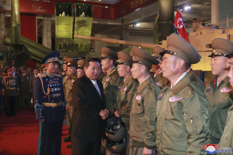 North Korean leader Kim Jong-un meets fighter pilots at the opening of an exhibition of weapons systems in Pyongyang.