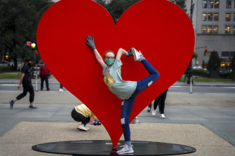 Jada Cathcart, 16, poses for a picture in front of â€œThe Hero Monumentâ€ in New York by Italian sculptor Sergio Furnari, a symbol of hope and love dedicated to healthcare workers around the world.