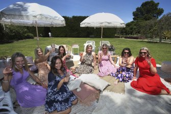 One group at St Kilda Botanical Gardens brought champagne buckets and iPads to watch the race.