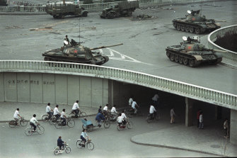 Tanks stationed on an overpass two days after the Tiananmen Square massacre. The slogan on the wall at left reads: "Strike down martial law."