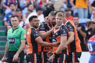 The Tigers celebrate a try from Adam Doueihi during Sunday’s upset NRL win over Newcastle.