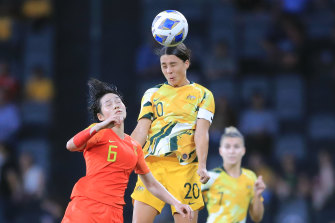 Sam Kerr of the Matildas contests a header with Zhang Xin of China in their Olympic qualifier earlier this month.