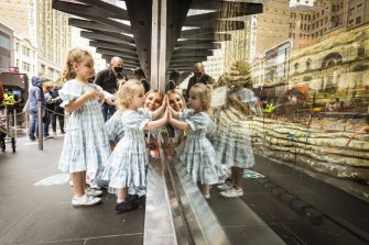 Hundreds of Melburnians, including Lorinska Merrington and her daughters Penelope, 5, and Florence, 2, stood in line to see the first showing of Myers Christmas windows.