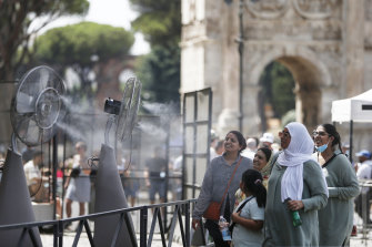 People cool down in front of fans at the Colosseum during last year’s heat wave.