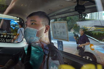 In this July 6, 2020, file photo, Tong Ying-kit arrives at a court in a police van in Hong Kong.