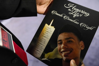 A mourner holds a program for the funeral services of Daunte Wright at Shiloh Temple International Ministries in Minneapolis.