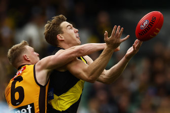 Tight battle: Hawthorn’s James Sicily and Tiger Tom Lynch.