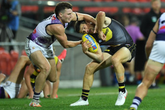 Trent Cotchin is collared by Blake Acres.