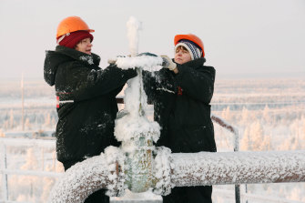 Workers control a pressure valve at an Lukoil reservoir in the Komy autonomous district of Russia. The sudden withdrawal of Russian oil supplies from the global market sent prices to seven-year highs. 