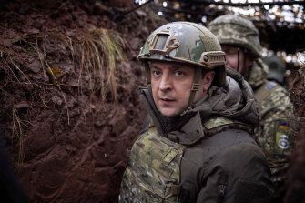 Ukrainian President Volodymyr Zelensky, walks under a camouflage net in a trench as he visits the war-hit Donetsk region, eastern Ukraine.