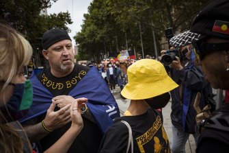 A man draped in an Australian flag and wearing a Proud Boys T-shirt  clashed with protesters.