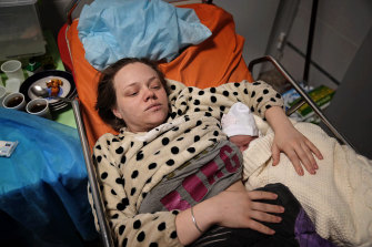 Mariana Vishegirskaya cradles her daughter Veronika in a hospital bed after surviving the air strike on the maternity hospital. 